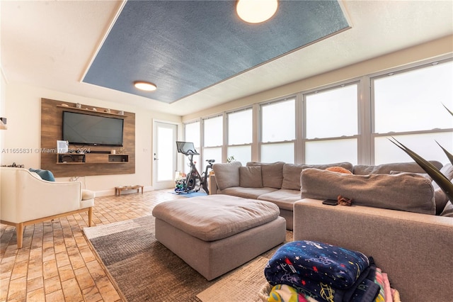 living room featuring a wealth of natural light and a textured ceiling