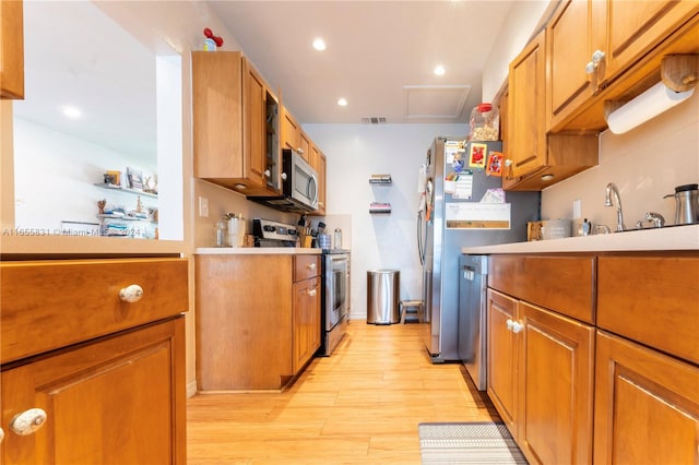 kitchen featuring stainless steel appliances and light hardwood / wood-style floors