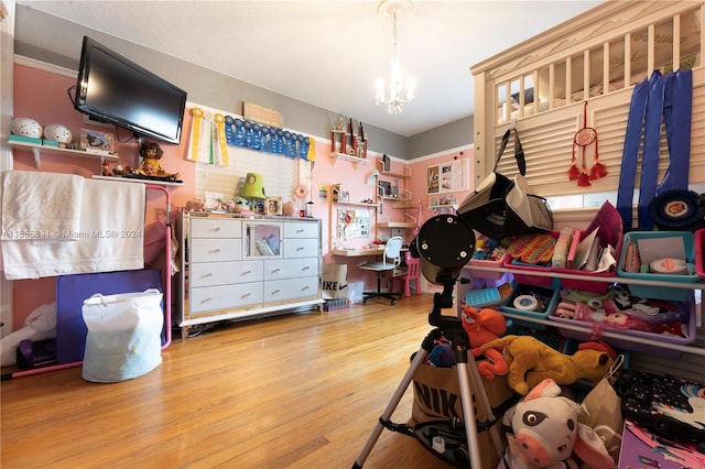 bedroom featuring light hardwood / wood-style floors and a notable chandelier