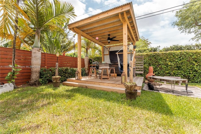 view of yard featuring ceiling fan and a deck