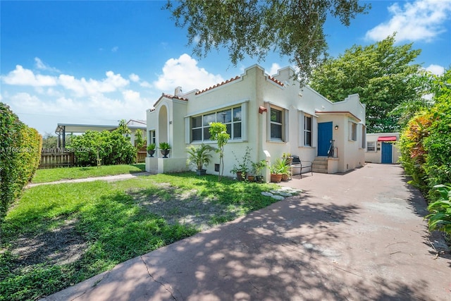 mediterranean / spanish house with a front lawn