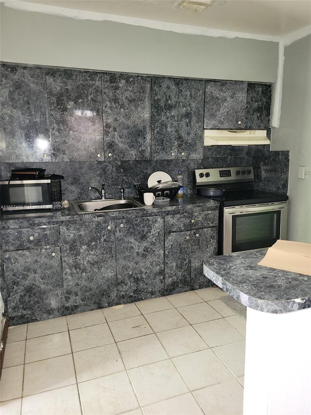 kitchen featuring appliances with stainless steel finishes, light tile patterned floors, tasteful backsplash, and sink