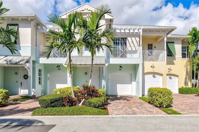 view of front of home featuring a balcony and a garage