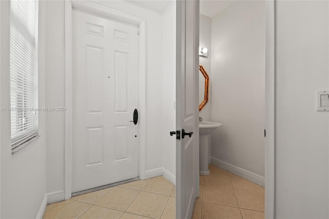 interior space with a healthy amount of sunlight, tile patterned flooring, and sink