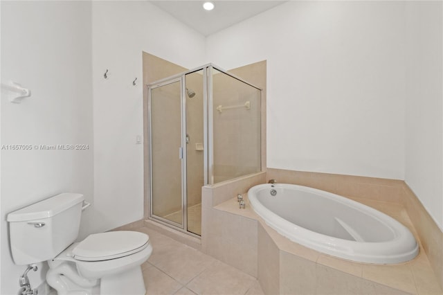 bathroom featuring plus walk in shower, tile patterned flooring, and toilet