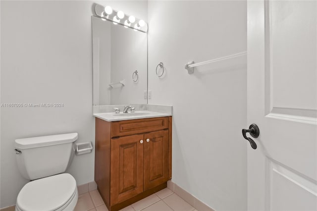 bathroom with tile patterned flooring, vanity, and toilet