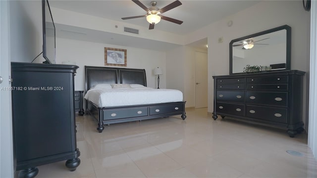 tiled bedroom featuring ceiling fan