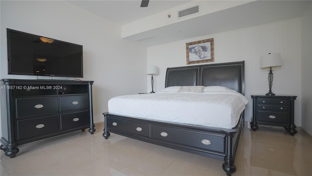 tiled bedroom featuring ceiling fan