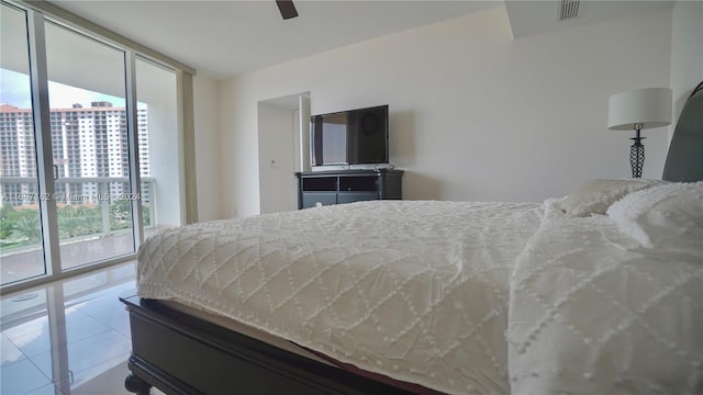 bedroom with floor to ceiling windows, ceiling fan, light tile patterned floors, and access to exterior