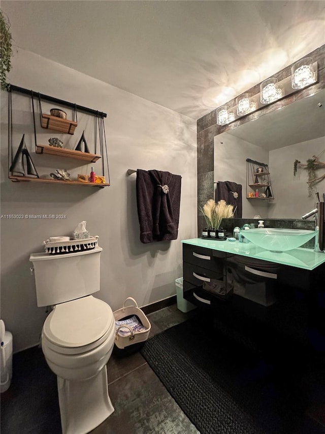 bathroom featuring toilet and vanity