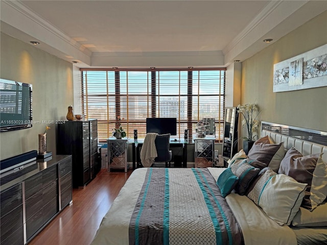 bedroom with ornamental molding and hardwood / wood-style floors