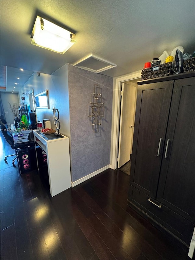 kitchen with dark hardwood / wood-style flooring and a textured ceiling