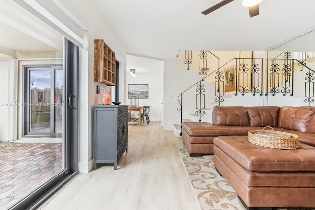 living room with ceiling fan and light wood-type flooring