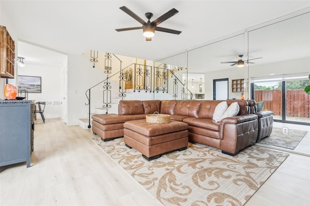 living room featuring light hardwood / wood-style floors and ceiling fan