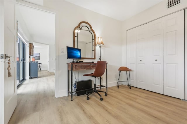 office with light hardwood / wood-style flooring