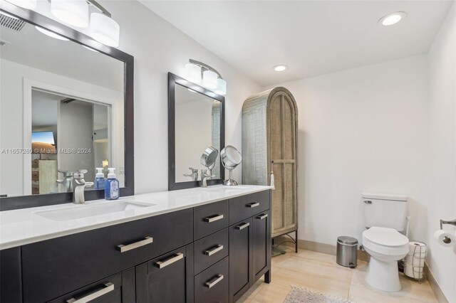 bathroom featuring vanity, toilet, and hardwood / wood-style flooring