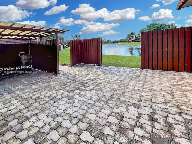 view of patio / terrace with a water view and a pergola