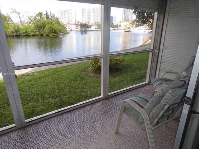 unfurnished sunroom featuring a water view