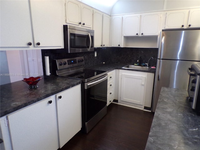 kitchen featuring dark hardwood / wood-style floors, sink, appliances with stainless steel finishes, and white cabinetry