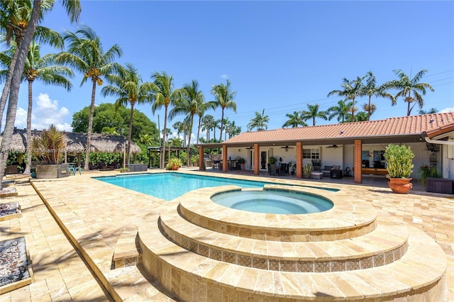 view of swimming pool featuring a patio area and an in ground hot tub