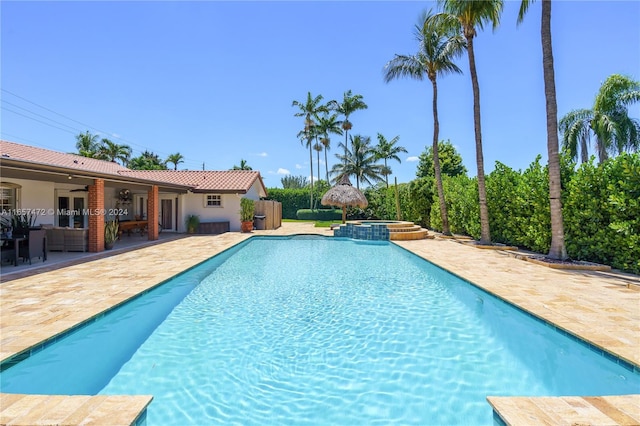 view of pool with a patio area and an in ground hot tub