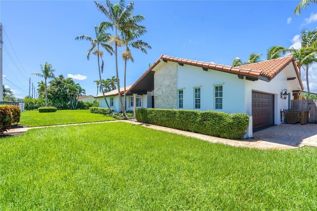 view of property exterior with a garage and a yard