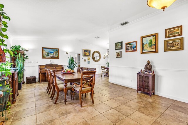 dining room featuring vaulted ceiling and ornamental molding