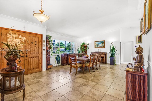 tiled dining room with crown molding