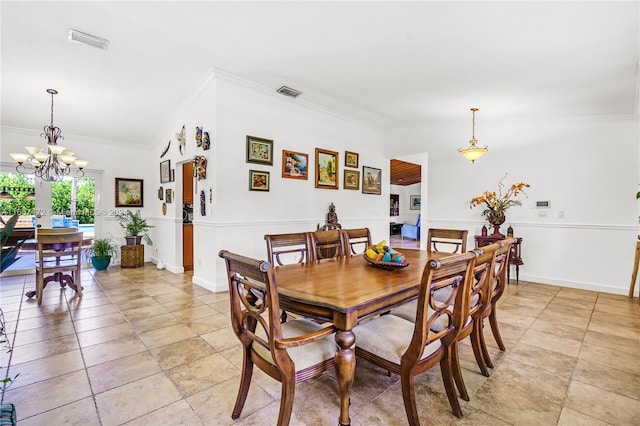 dining room with lofted ceiling, crown molding, and a notable chandelier