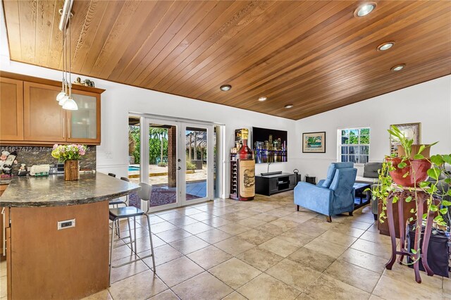 living room with vaulted ceiling, french doors, and wood ceiling