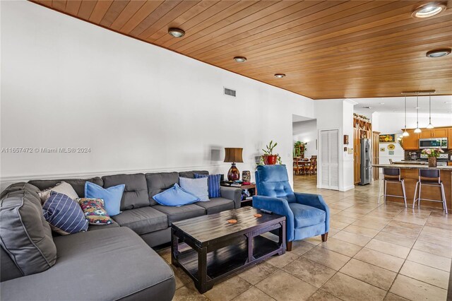 living room featuring wooden ceiling and light tile patterned flooring