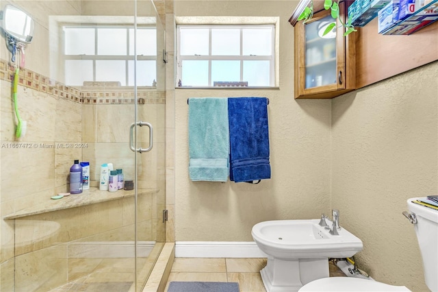 bathroom featuring walk in shower, toilet, a bidet, and tile patterned flooring