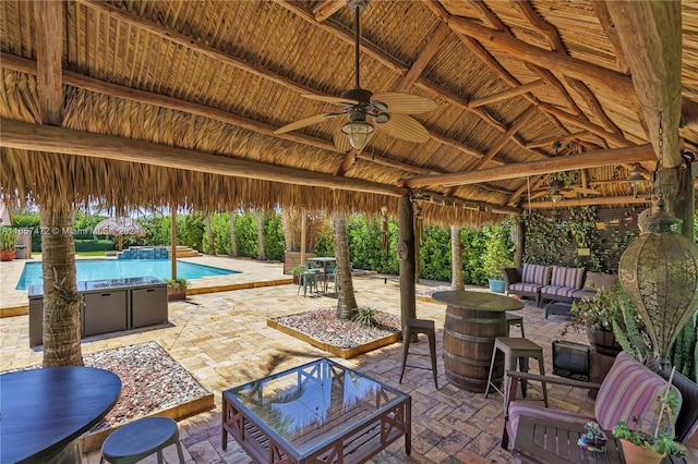 view of patio / terrace with an outdoor living space, ceiling fan, and a gazebo