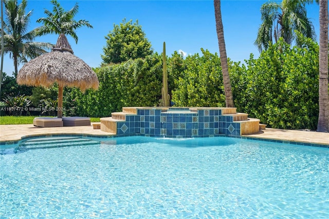 view of swimming pool with pool water feature