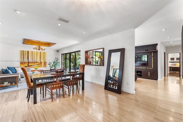 dining area with an inviting chandelier