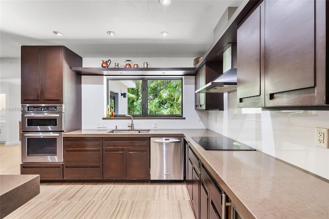 kitchen with backsplash, sink, wall chimney exhaust hood, dark brown cabinets, and stainless steel appliances