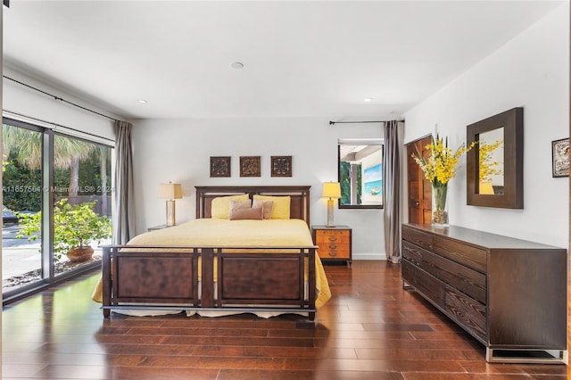 bedroom with dark hardwood / wood-style floors and access to outside