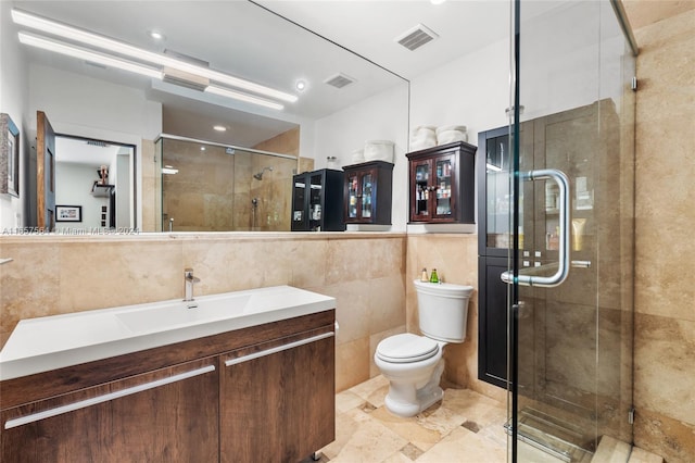 bathroom with vanity, toilet, tile walls, and walk in shower