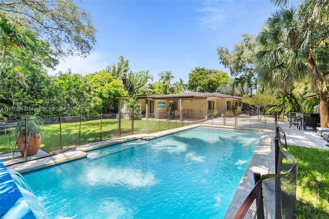 view of swimming pool with a lawn