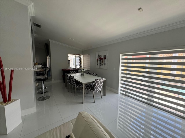 unfurnished dining area with ornamental molding, light tile patterned flooring, and plenty of natural light