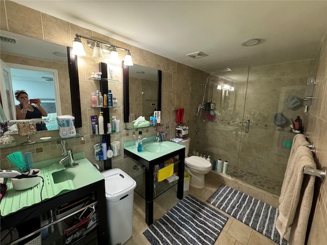 bathroom with tile walls, tasteful backsplash, vanity, walk in shower, and toilet