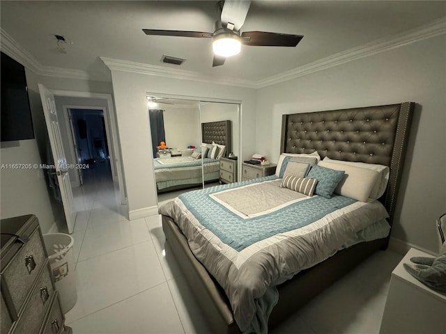 bedroom featuring ceiling fan, a closet, crown molding, and light tile patterned floors