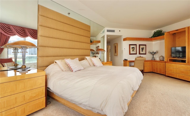 bedroom featuring vaulted ceiling and light colored carpet