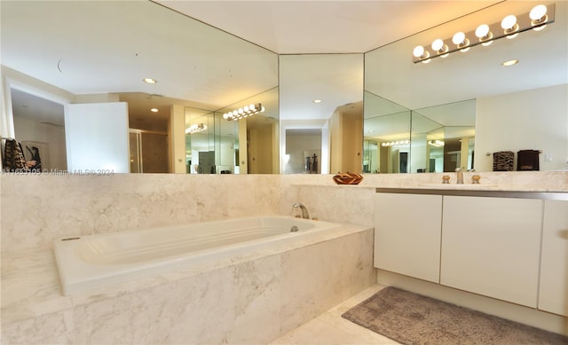 bathroom with tile patterned floors, separate shower and tub, and vanity