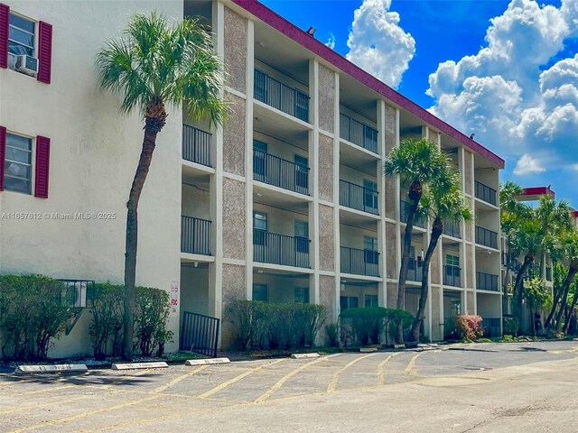 view of building exterior with uncovered parking