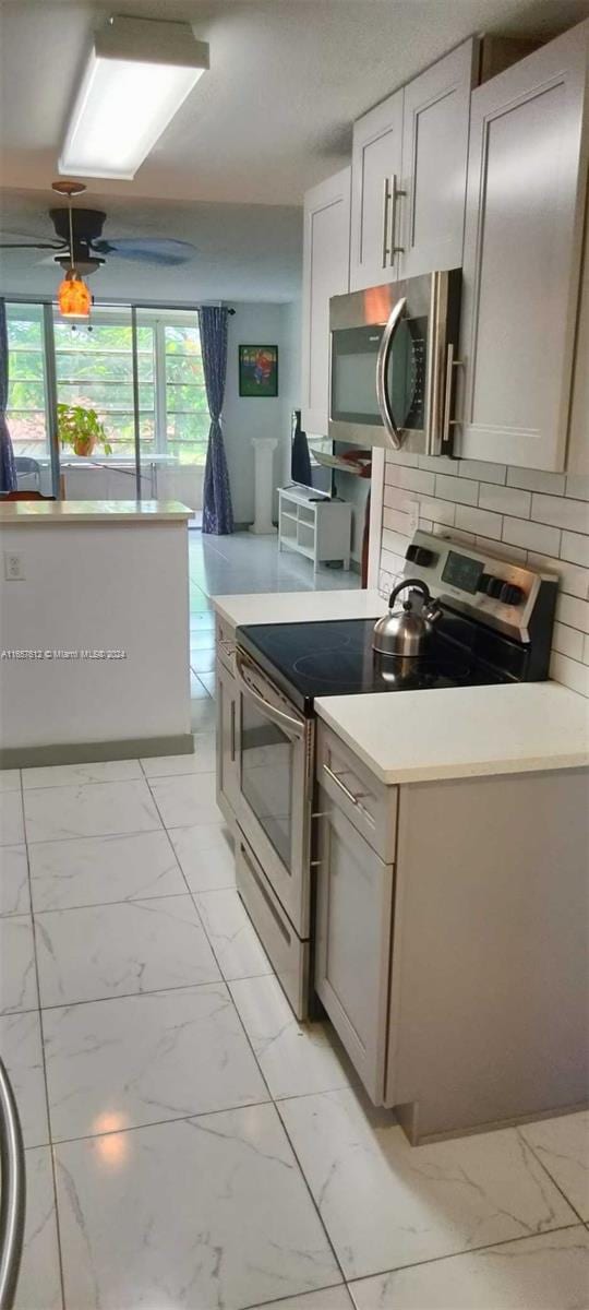 kitchen featuring appliances with stainless steel finishes and decorative backsplash