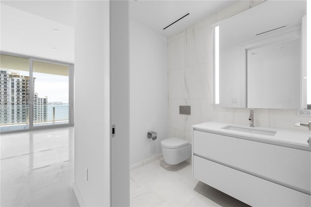 bathroom with vanity, tile walls, and toilet