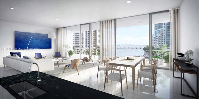 dining area with a water view, sink, and a wall of windows