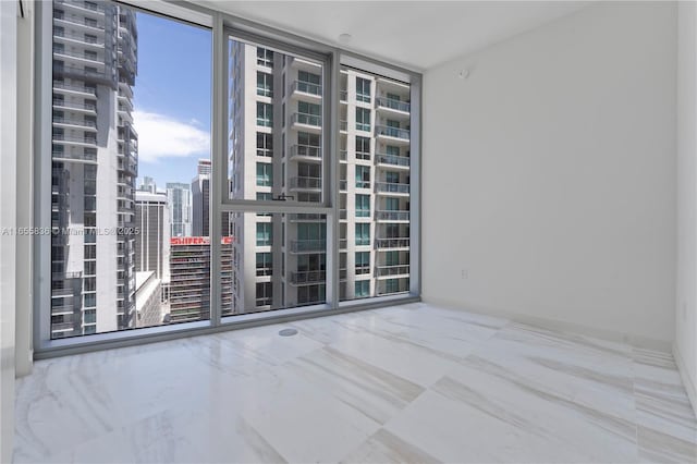 unfurnished room featuring floor to ceiling windows