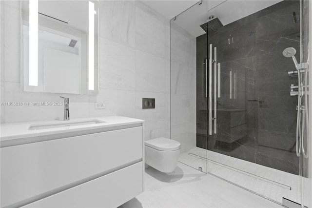 bathroom with vanity, toilet, a shower with door, and tile walls